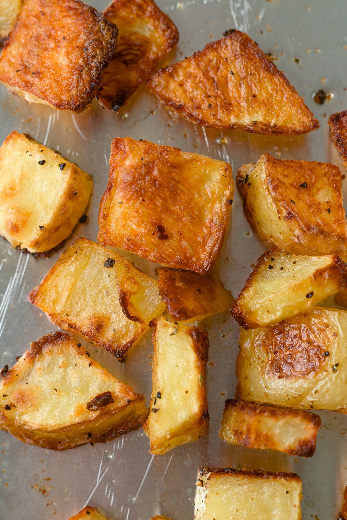 Crispy roasted potatoes on baking sheet.