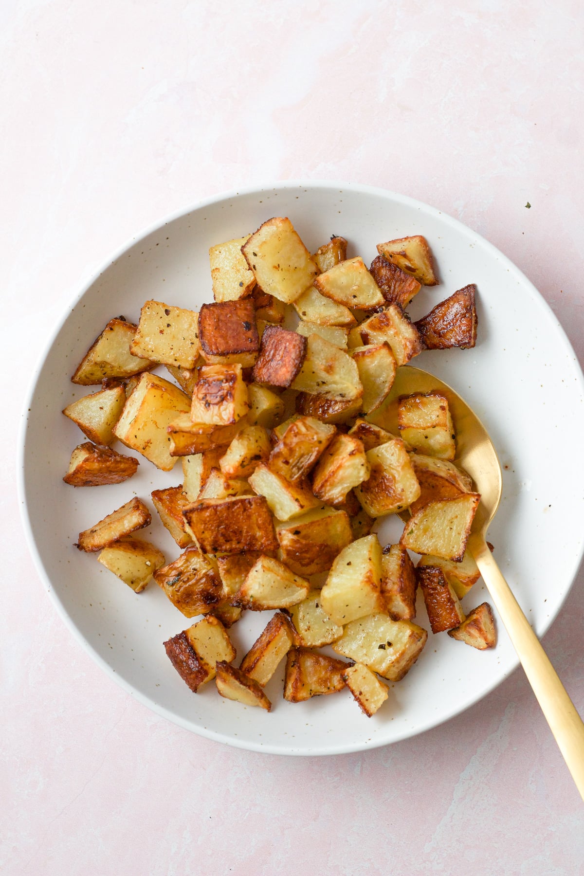 Roasted potatoes in serving dish.