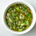 Small bowl of grilled scallion chimichurri sauce.