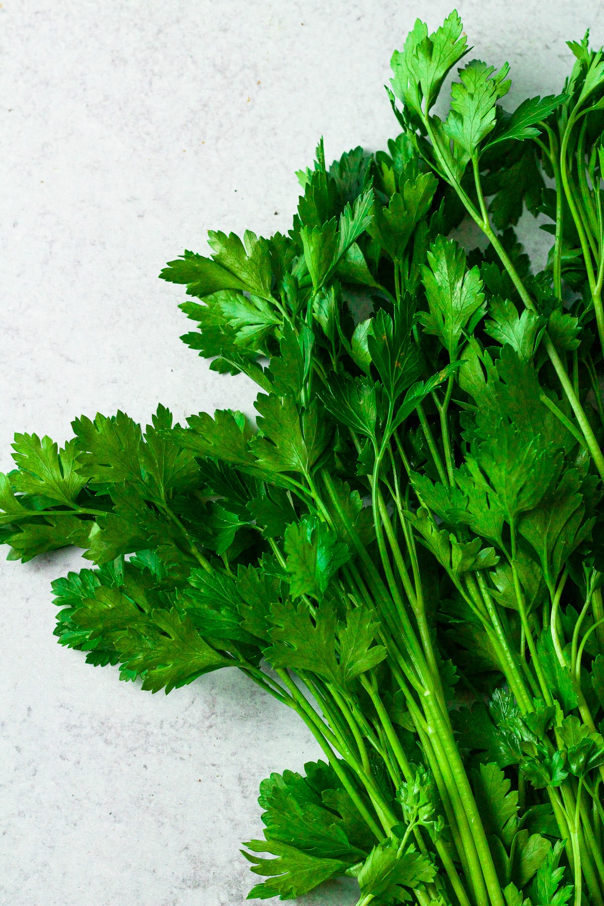 Flat-leaf parsley on board.