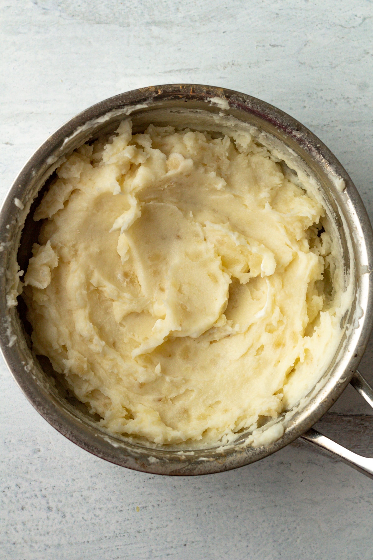 Mashed potatoes in small pot.