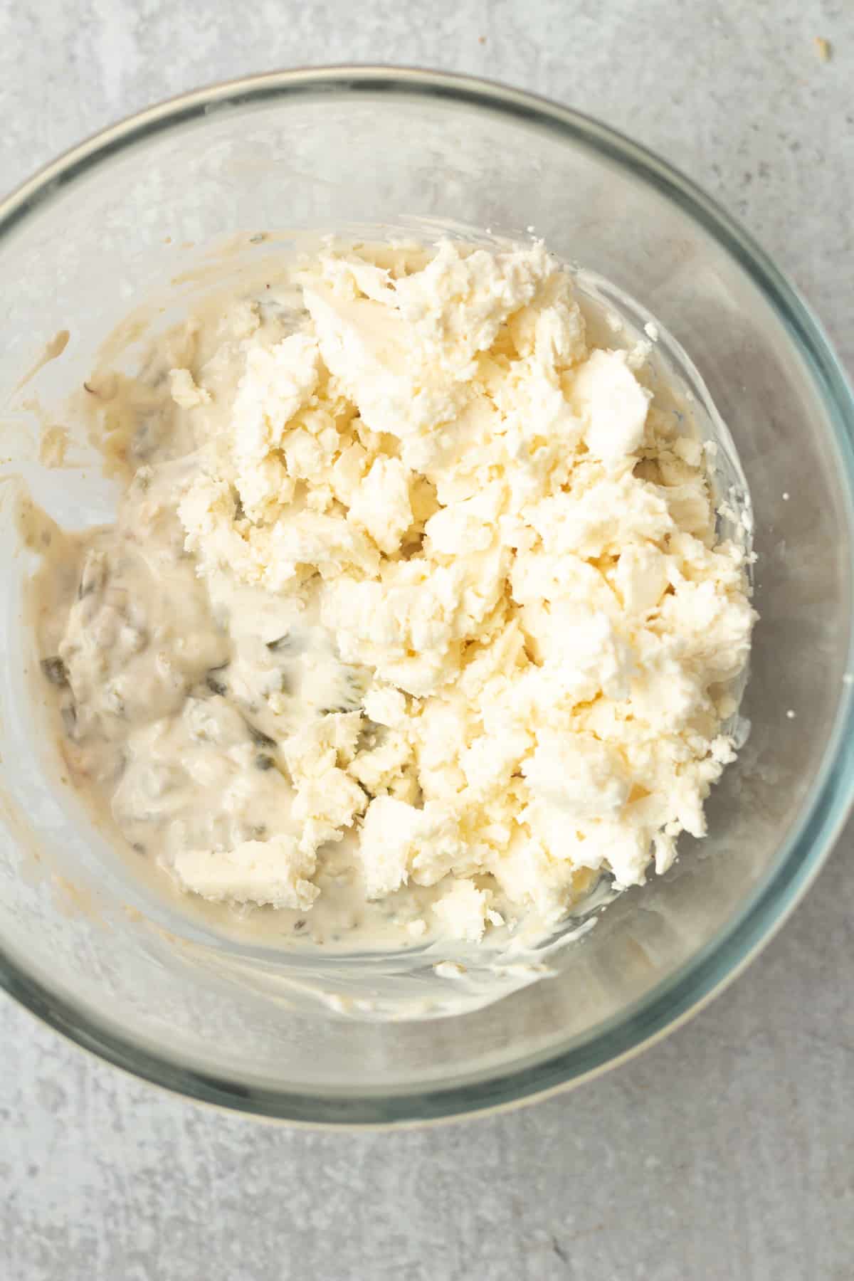 Bowl with yogurt and crumbled feta cheese.