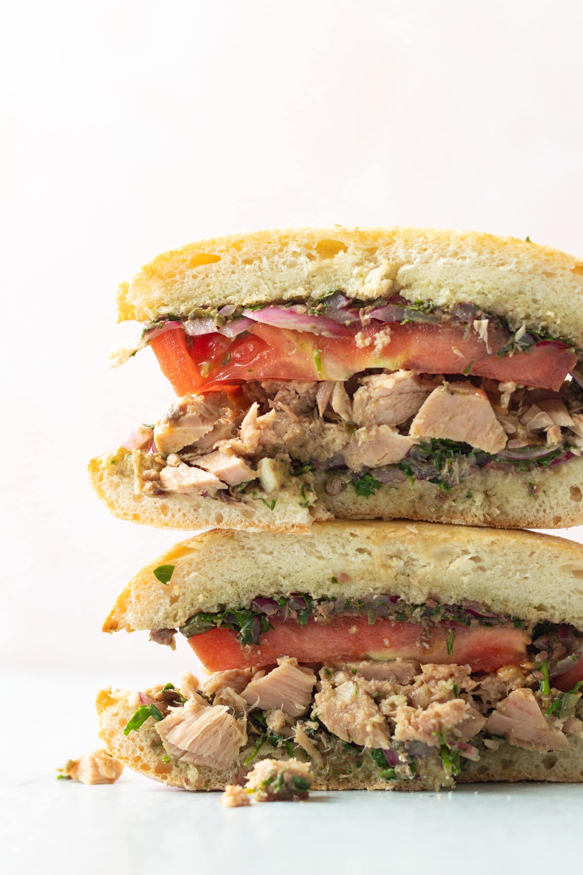 Cut tuna sandwich halves stacked.