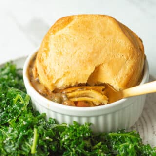 Chicken pot pie on plate with spoon scooping up bite.