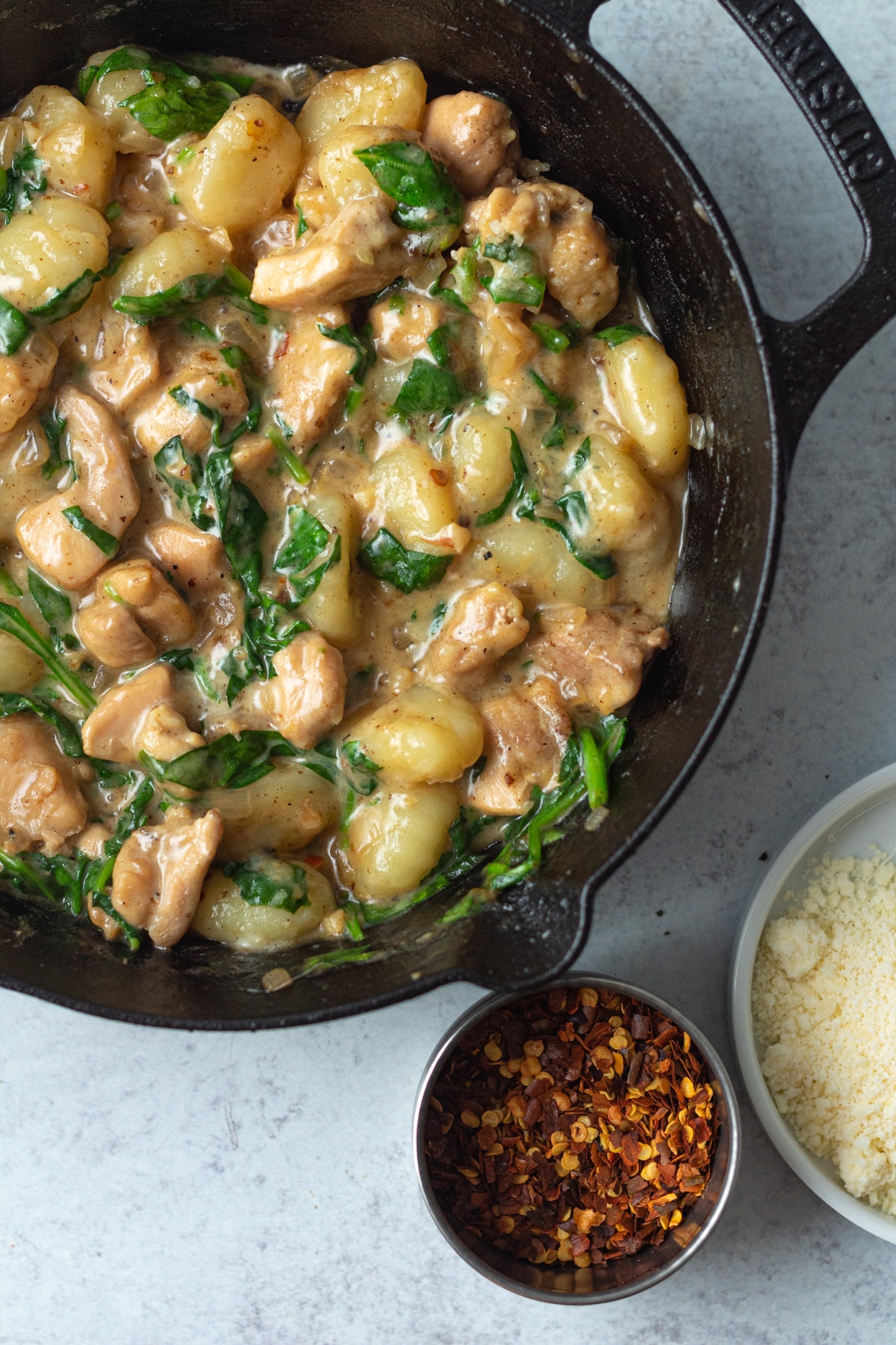 One pan creamy chicken and gnocchi in cast iron pan.