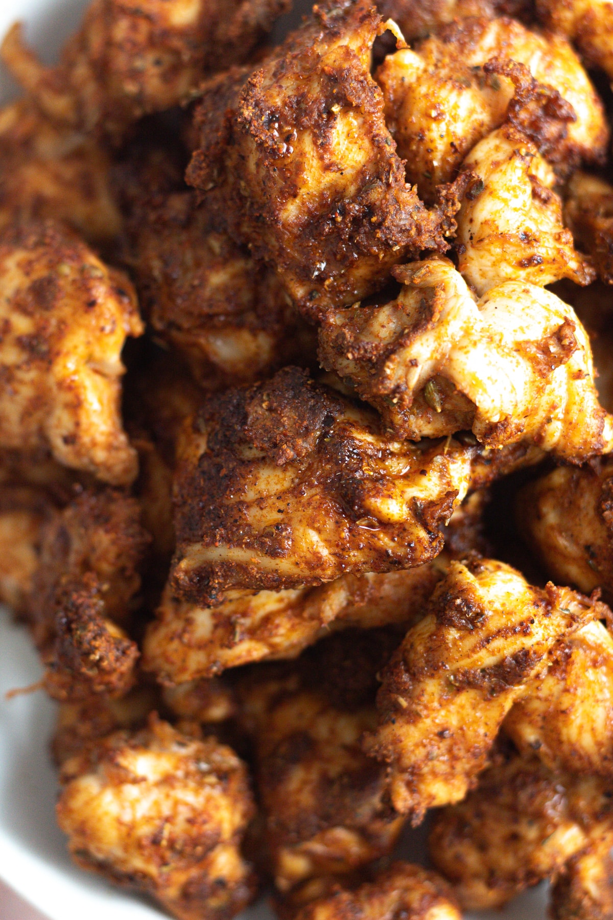 Close up shot of chicken bites on plate.